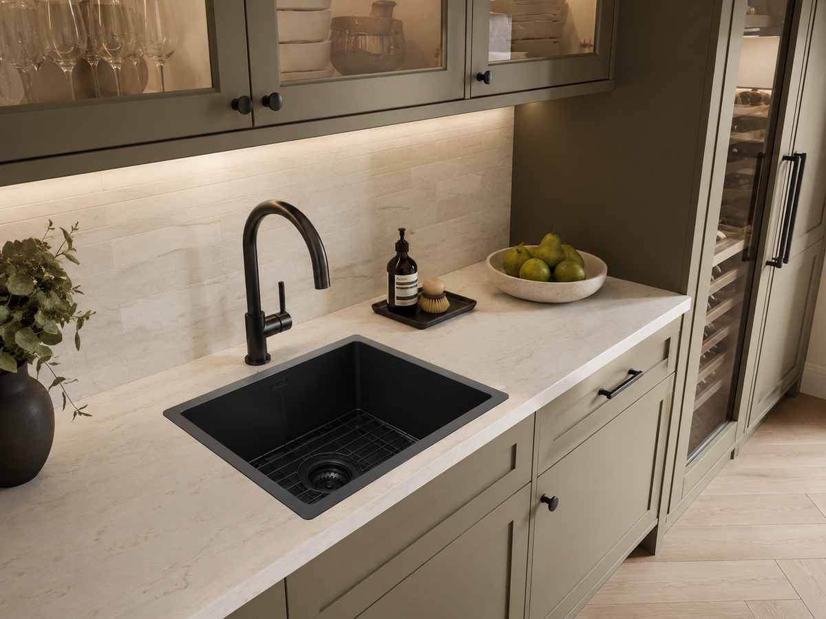 Hand fabricated PVD black main bowl stainless steel sink installed in a kitchen