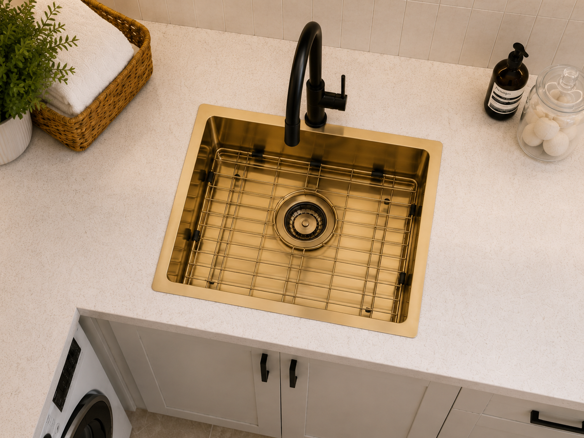 Hand fabricated PVD brass main bowl stainless steel sink installed in a laundry